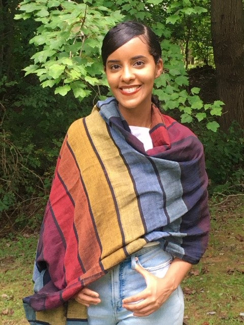 Aida wears a Shoo for Good scarf, enhanced with Insect Shield, that repels mosquitoes and other insects, Every wrap gives back to the fight against malaria, working with our partner, Nothing But Nets.. 