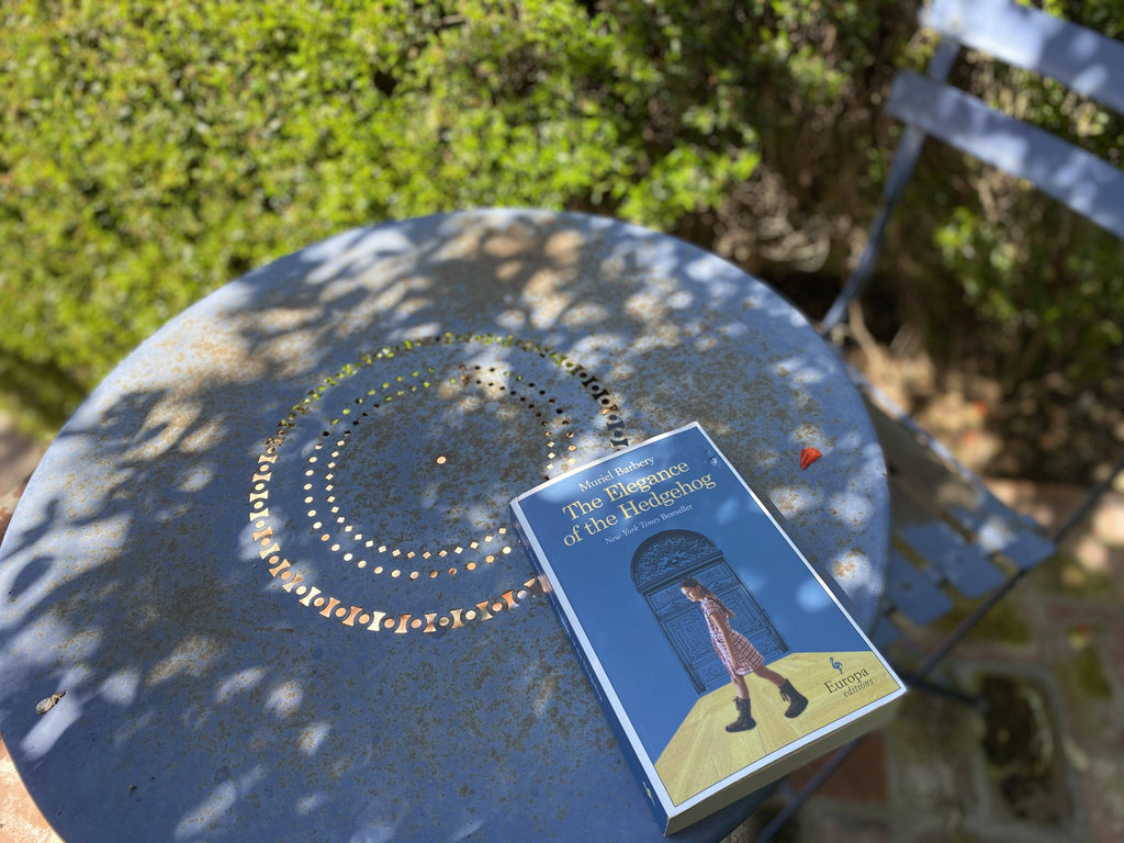 We may not be traveling but we can get away outside with a good book. Here, a book on a garden table.