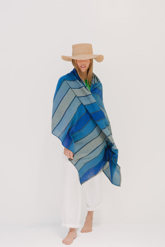Shoo for Good's Camellia wrap in blue stripes is chic and effective. Worn over white pants and a straw hat, the model looks ready for vacation. Our tick-repellent and mosquito-repellent Shoo for Good shawl is enhanced with Insect Shield permethrin and is effective for 70 washings. Invisible tick protection. An Oprah favorite for DEET-free protection.