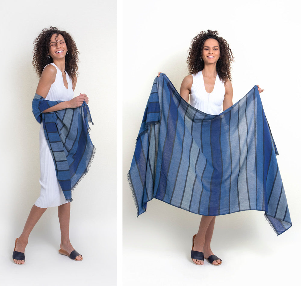 The insect-repellent Camellia wrap in blue stripes is worn  over a white dress in studio and is displayed by our model to show its ample size. Our tick-repellent and mosquito-repellent shawl is enhanced with Insect Shield permethrin and is effective at repelling ticks and mosquitoes for 70 washings. Invisible tick protection. An Oprah favorite for DEET-free protection.